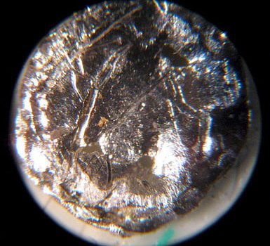 This is a disk of americium-241 viewed under a microscope. Bionerd, Creative Commons License