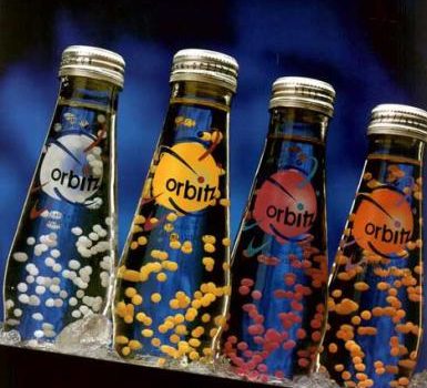 Orbitz Soda contains edible gelatin beads that float suspended in the soda because they are the same density as the liquid. Goleh, public domain
