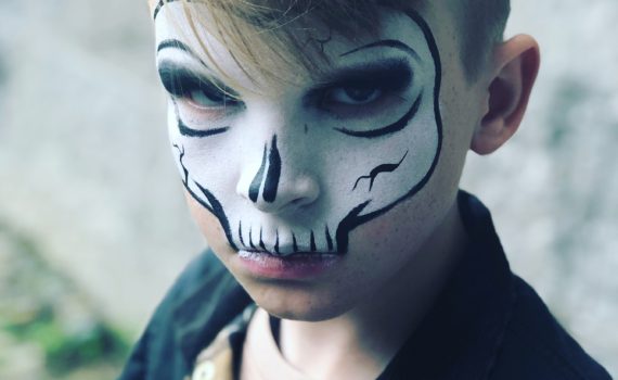 Use white face paint and black eyeliner to make a simple skeleton costume.