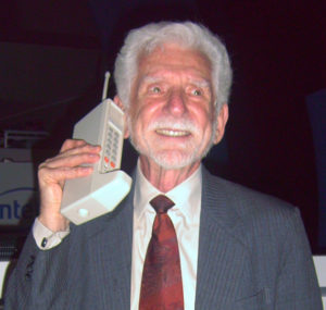 Martin Cooper and the prototype DynaTAC cellphone.